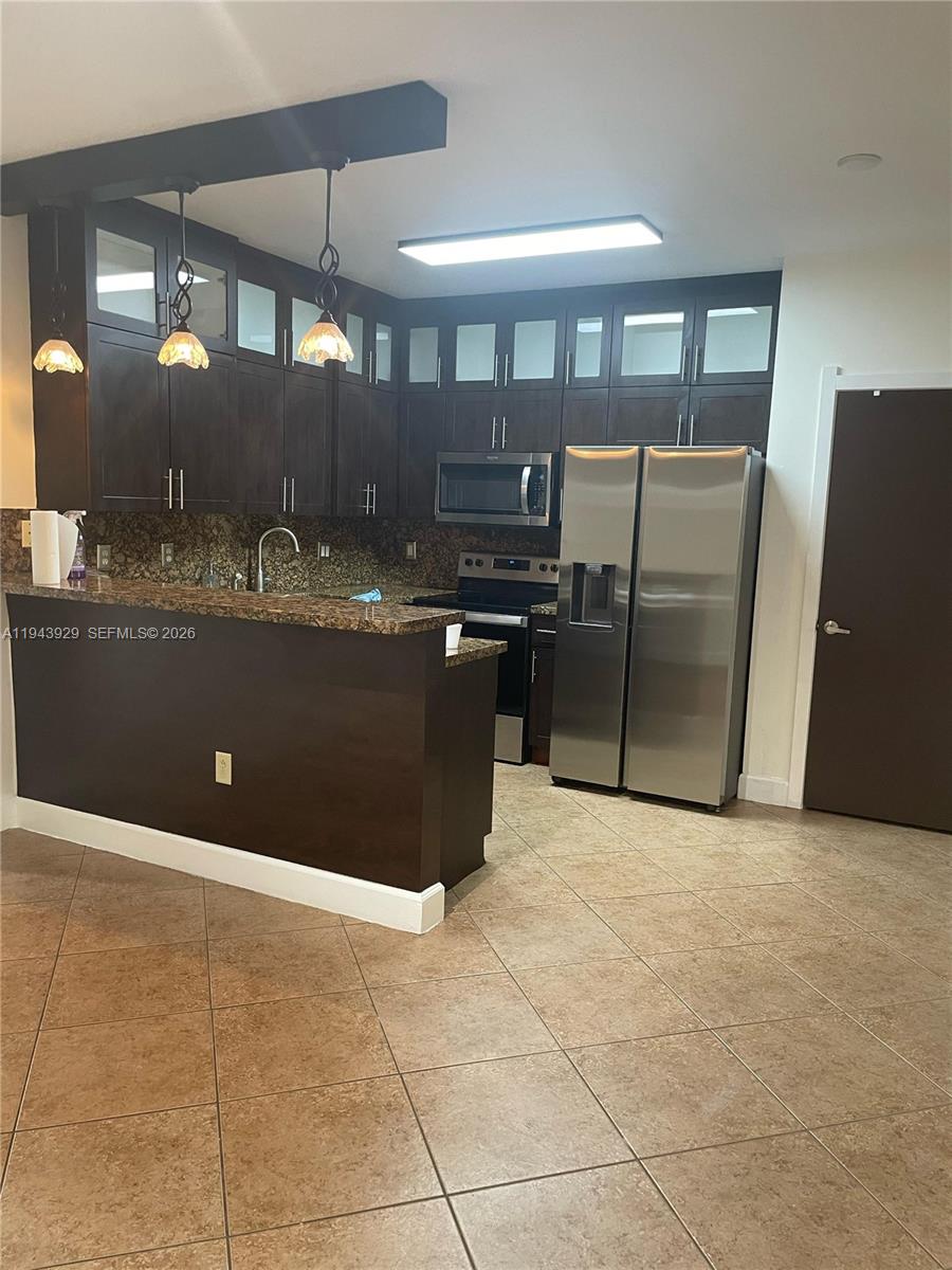 11115 West Okeechobee Road, Unit 154 Hialeah Gardens, FL 33018 - Photo 10 of 30 a view of a kitchen counter top space and stainless steel appliances