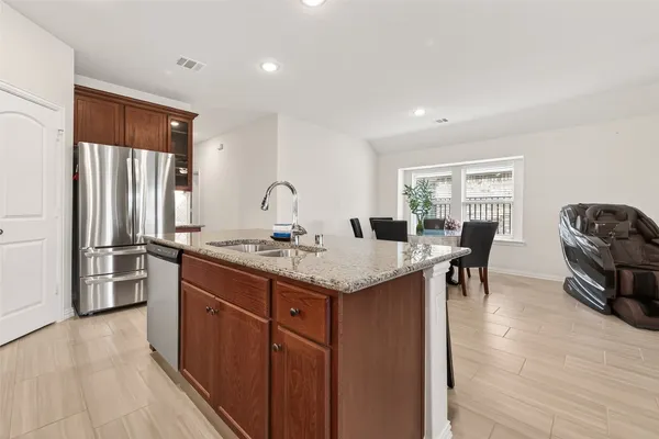 a kitchen with granite countertop sink dining table and chairs