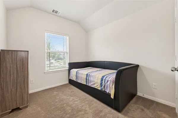 a close up of a bed in a room