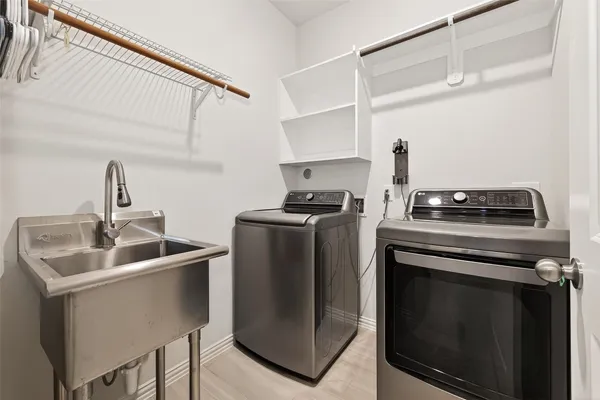 a bedroom with a bed and a flat tv screen on the dresser