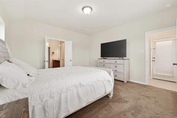 a bedroom with a flat screen television and a bed