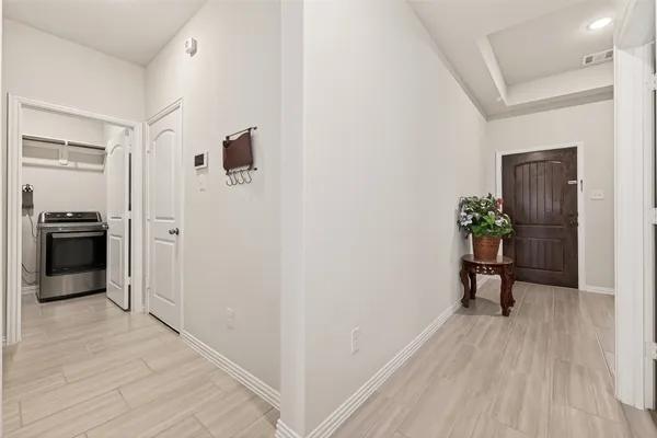 a view of a hallway view with wooden floor and furniture