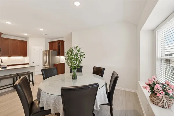 a dining room with furniture and potted plants