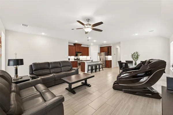 a living room with furniture and wooden floor
