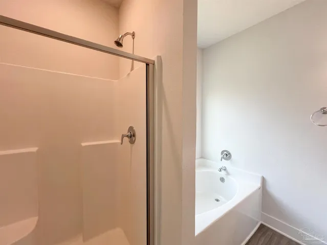 a bathroom with bathtub and shower