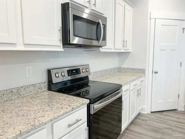 a kitchen with a refrigerator and cabinets