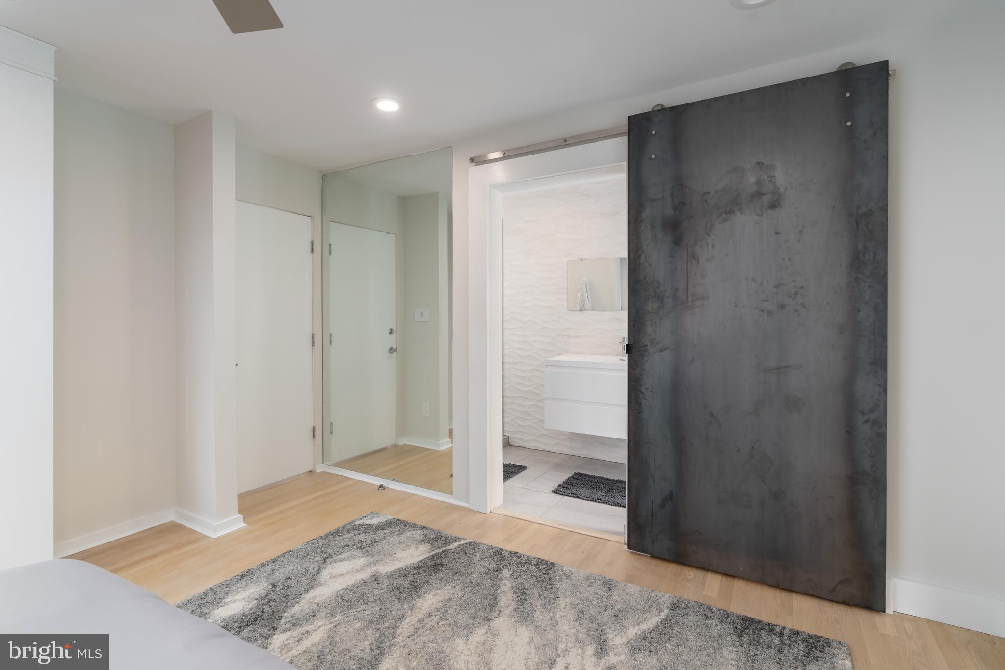 4770 Reservoir Road Northwest Washington, DC 20007 - Photo 32 of 50 Steel covered barn door to bath from 3rd bedroom