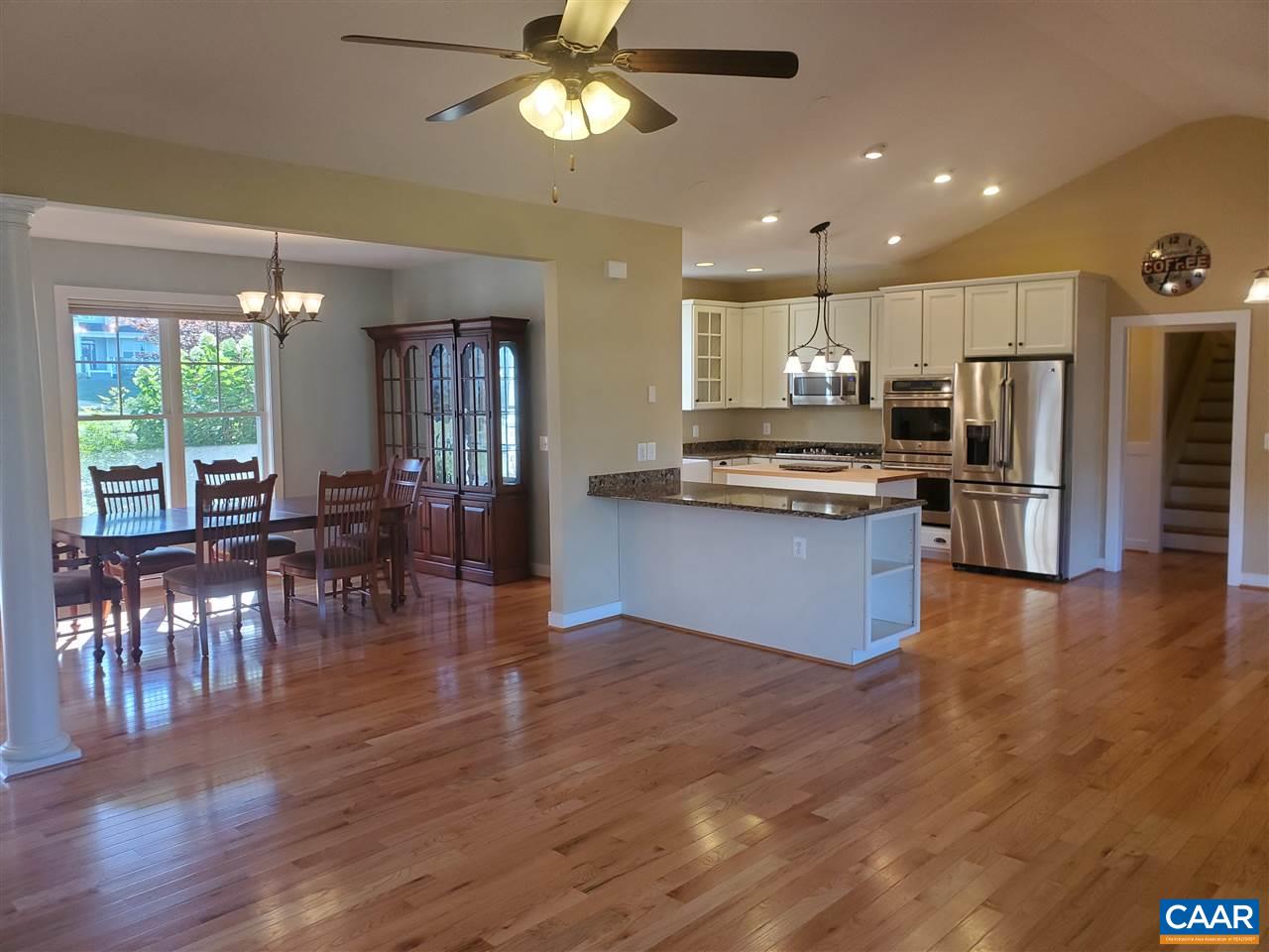 139 Wexford Ridge Road Ruckersville, VA 22968 - Photo 20 of 45 a kitchen with stainless steel appliances kitchen island granite countertop wooden floors and cabinets