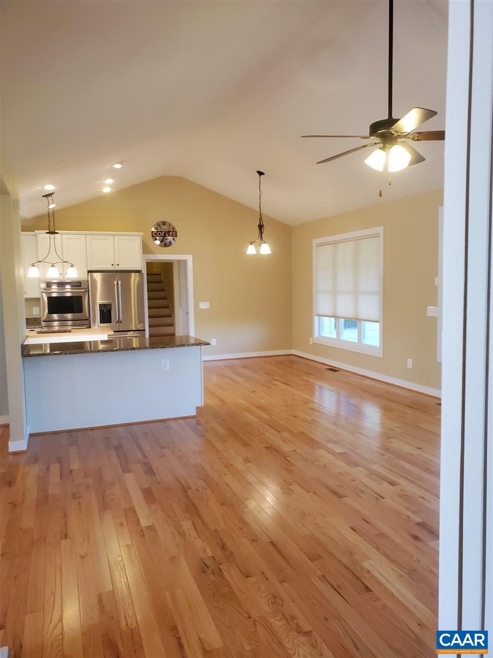 139 Wexford Ridge Road Ruckersville, VA 22968 - Photo 22 of 45 a view of kitchen and empty room with wooden floor