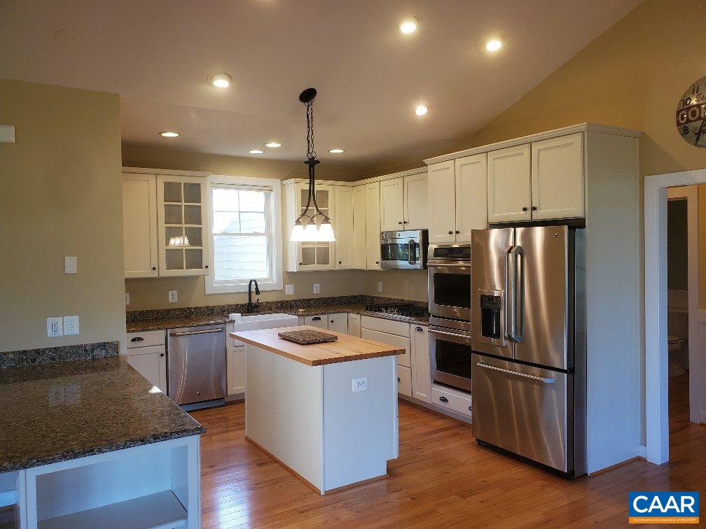 139 Wexford Ridge Road Ruckersville, VA 22968 - Photo 23 of 45 a kitchen with stainless steel appliances granite countertop a refrigerator a sink a stove a microwave and island
