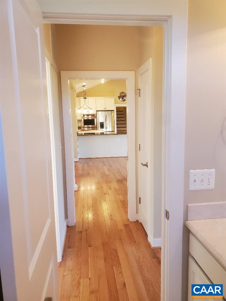 139 Wexford Ridge Road Ruckersville, VA 22968 - Photo 24 of 45 a view of a hallway with wooden floor and a bathroom