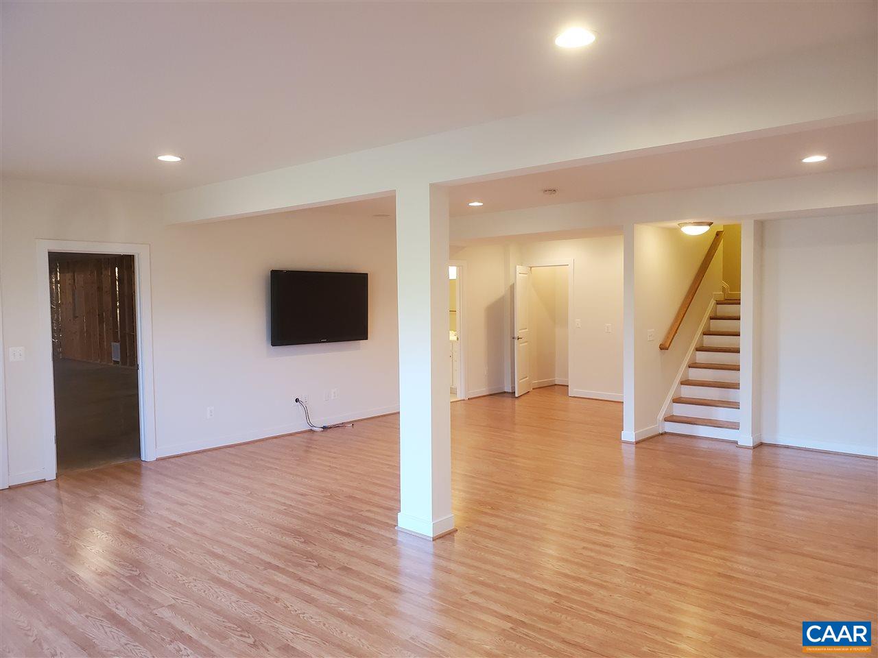139 Wexford Ridge Road Ruckersville, VA 22968 - Photo 35 of 45 a view of an empty room with wooden floor and stairs