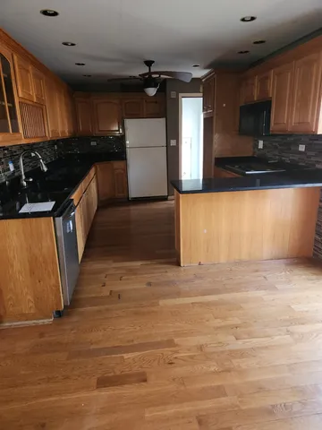 a kitchen with granite countertop a stove and cabinets