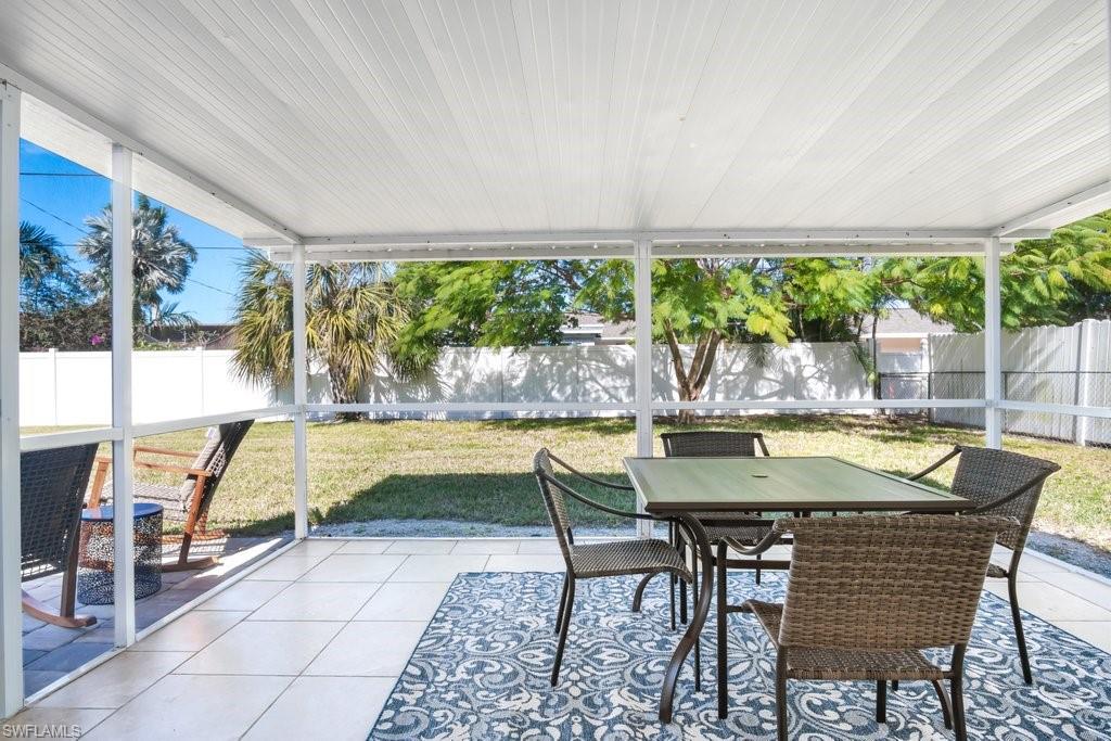 1207 Hernando Street Naples, FL 34103 - Photo 13 of 37 a view of swimming pool with outdoor seating and a garden