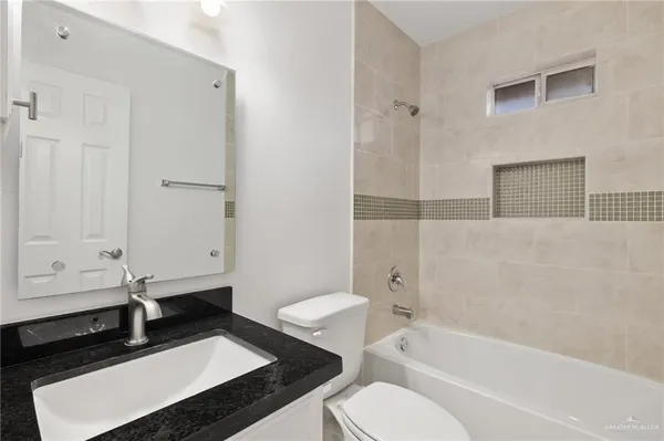 a bathroom with a sink a toilet and bathtub