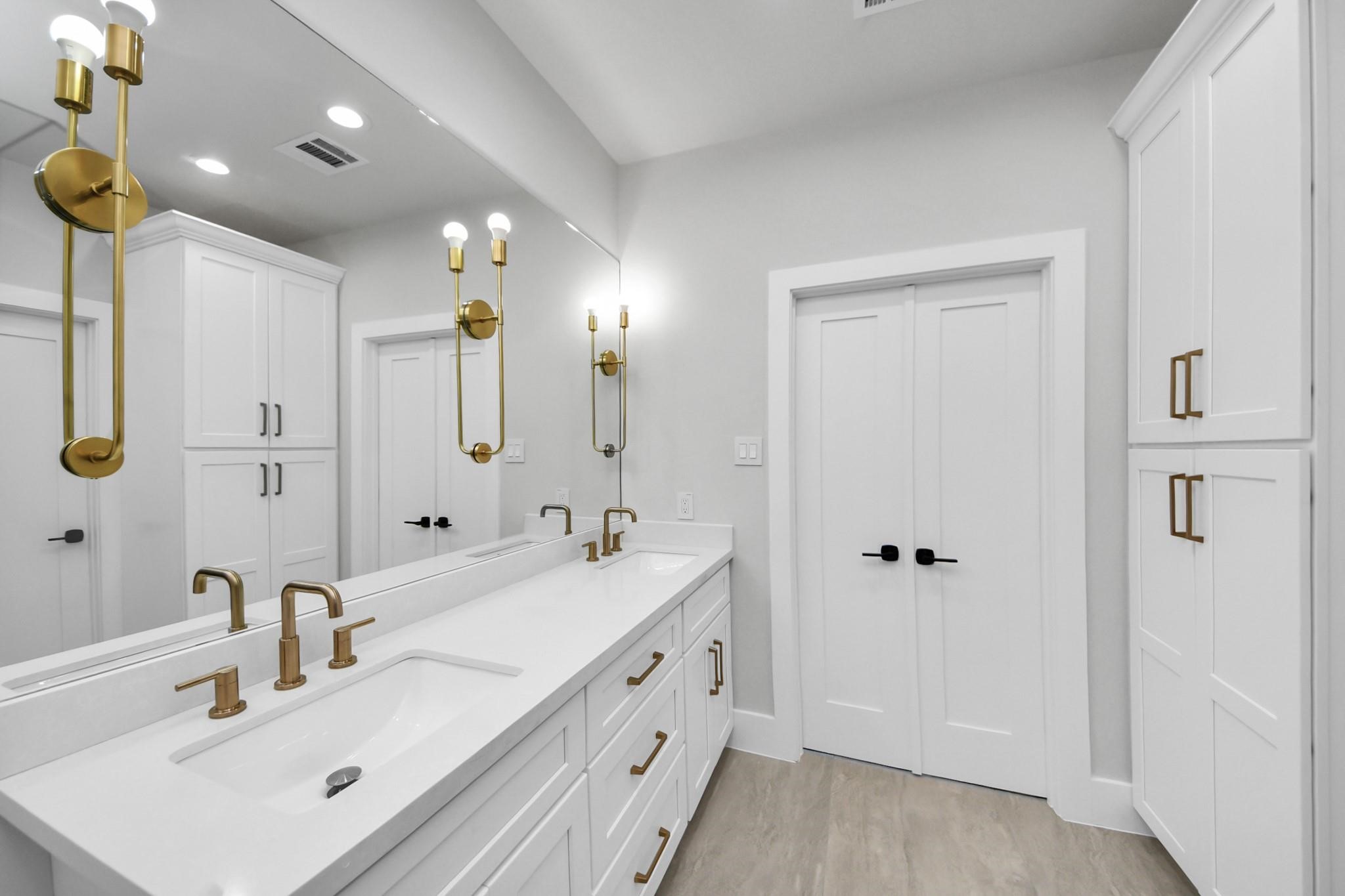 6320 Milwee Street, Unit B Houston, TX 77092 - Photo 22 of 30 a bathroom with a double vanity sink and mirror