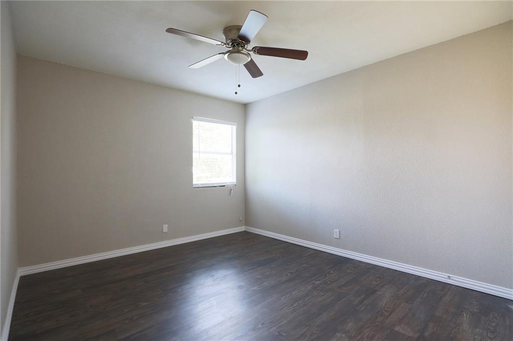 1410 Ransom Street Pflugerville, TX 78660 - Photo 12 of 22 Empty room featuring dark wood-style floors and ceiling fan