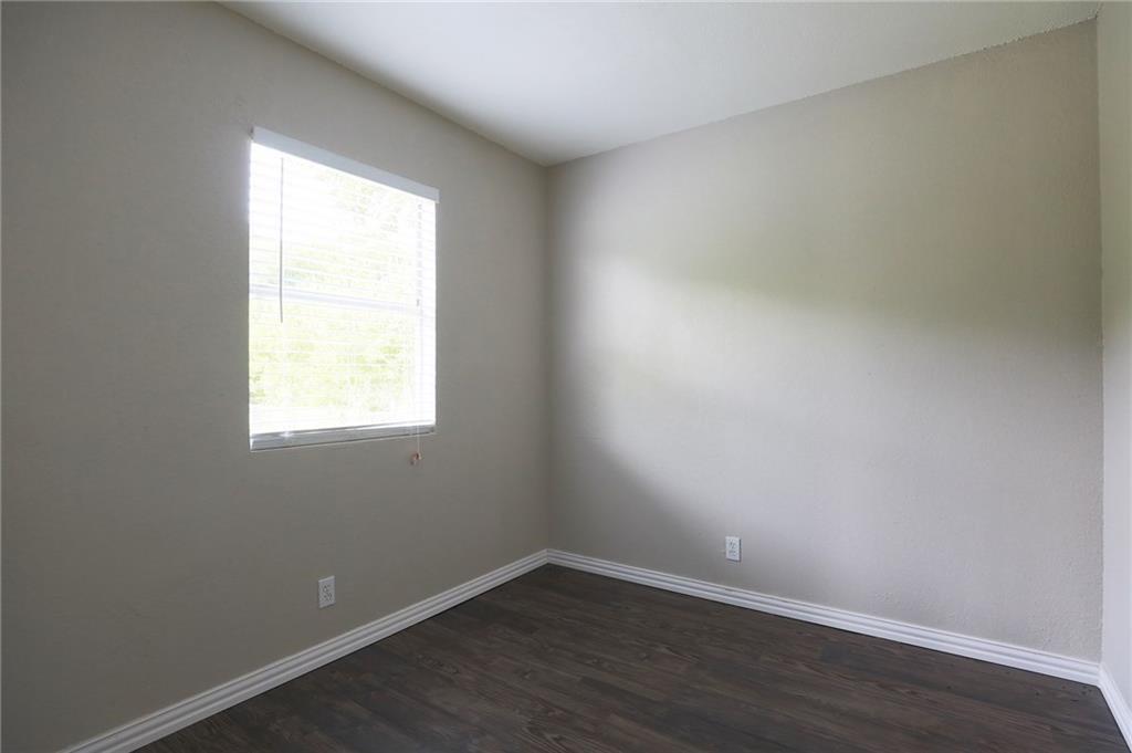 1410 Ransom Street Pflugerville, TX 78660 - Photo 14 of 22 Empty room featuring dark wood-style floors and baseboards