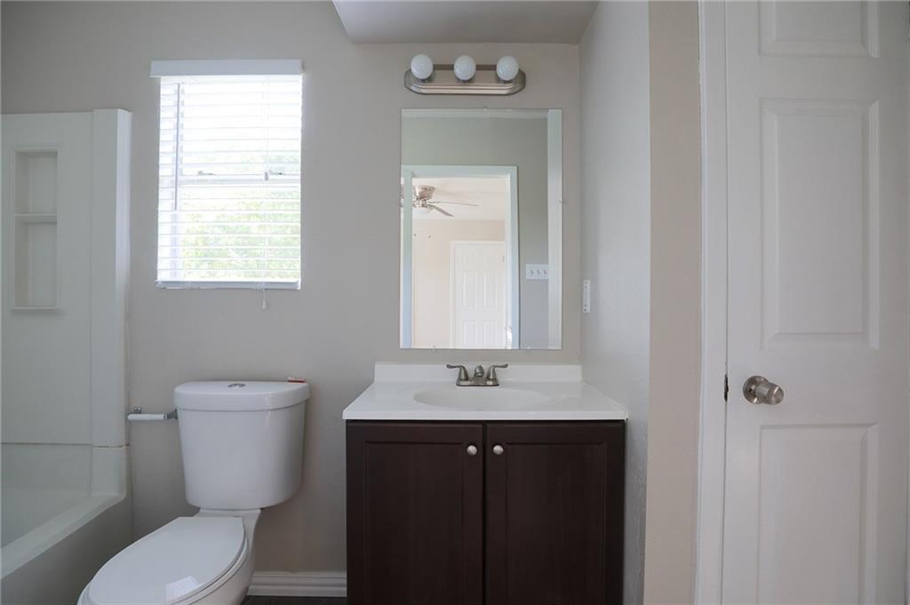 1410 Ransom Street Pflugerville, TX 78660 - Photo 17 of 22 Full bath featuring vanity and bathing tub / shower combination