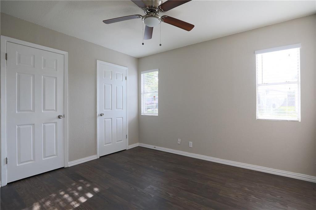 1410 Ransom Street Pflugerville, TX 78660 - Photo 18 of 22 Unfurnished bedroom with dark wood-type flooring and ceiling fan