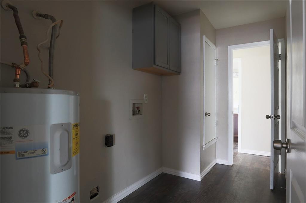 1410 Ransom Street Pflugerville, TX 78660 - Photo 21 of 22 Laundry room featuring water heater, cabinet space, washer hookup, and dark wood-type flooring