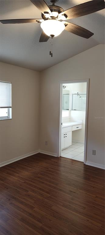 210 Chardonnay Place Valrico, FL 33594 - Photo 12 of 26 a view of an empty room with wooden floor and a window