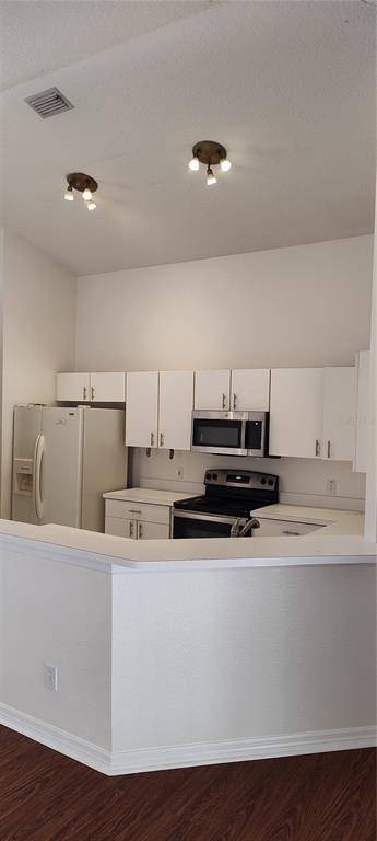 210 Chardonnay Place Valrico, FL 33594 - Photo 17 of 26 a kitchen with kitchen island a stove a sink and a microwave