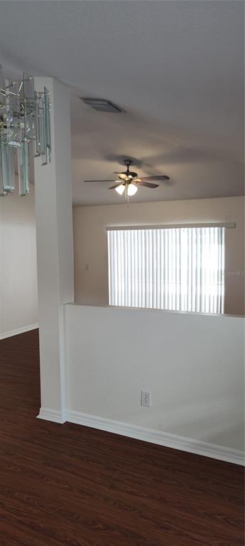 210 Chardonnay Place Valrico, FL 33594 - Photo 6 of 26 a view of an empty room with wooden floor and a window