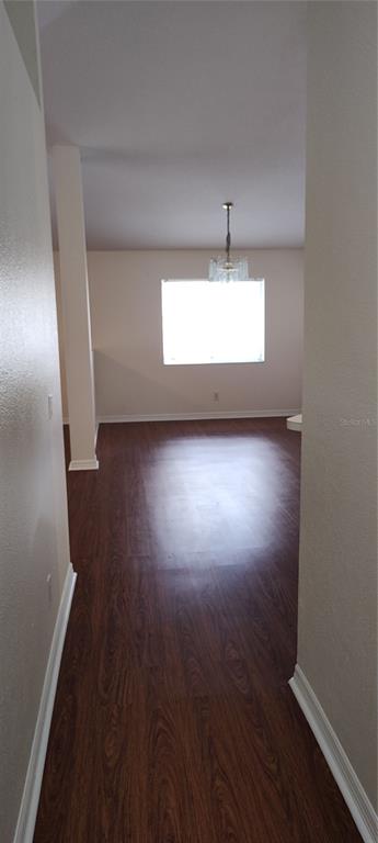 210 Chardonnay Place Valrico, FL 33594 - Photo 7 of 26 an empty room with wooden floor and windows