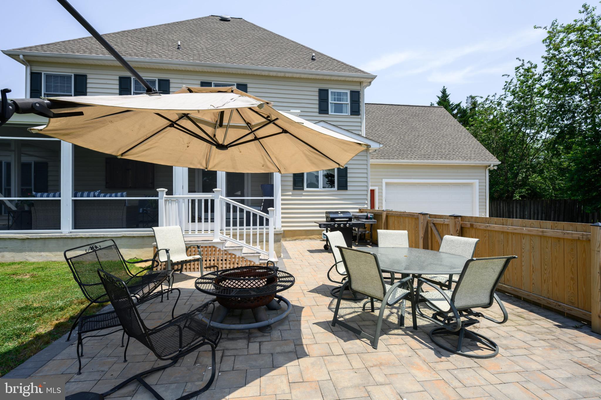 1009 South Washington Street Easton, MD 21601 - Photo 12 of 54 a view of a patio with table and chairs under an umbrella