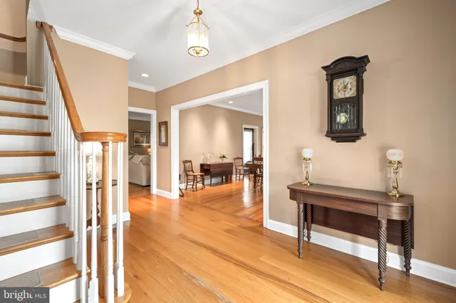 a view of a hallway with wooden floor and furniture