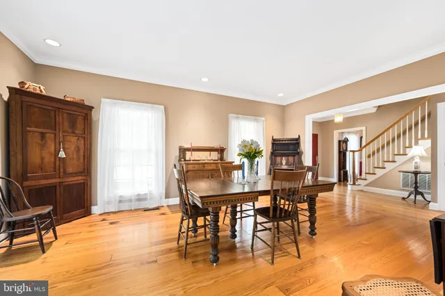 a dining room with furniture window and wooden floor