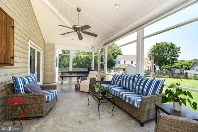 a balcony with furniture and a potted plant