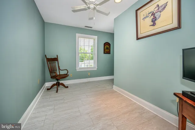 a view of room with workspace and windows