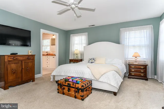 a bedroom with a bed and flat tv screen
