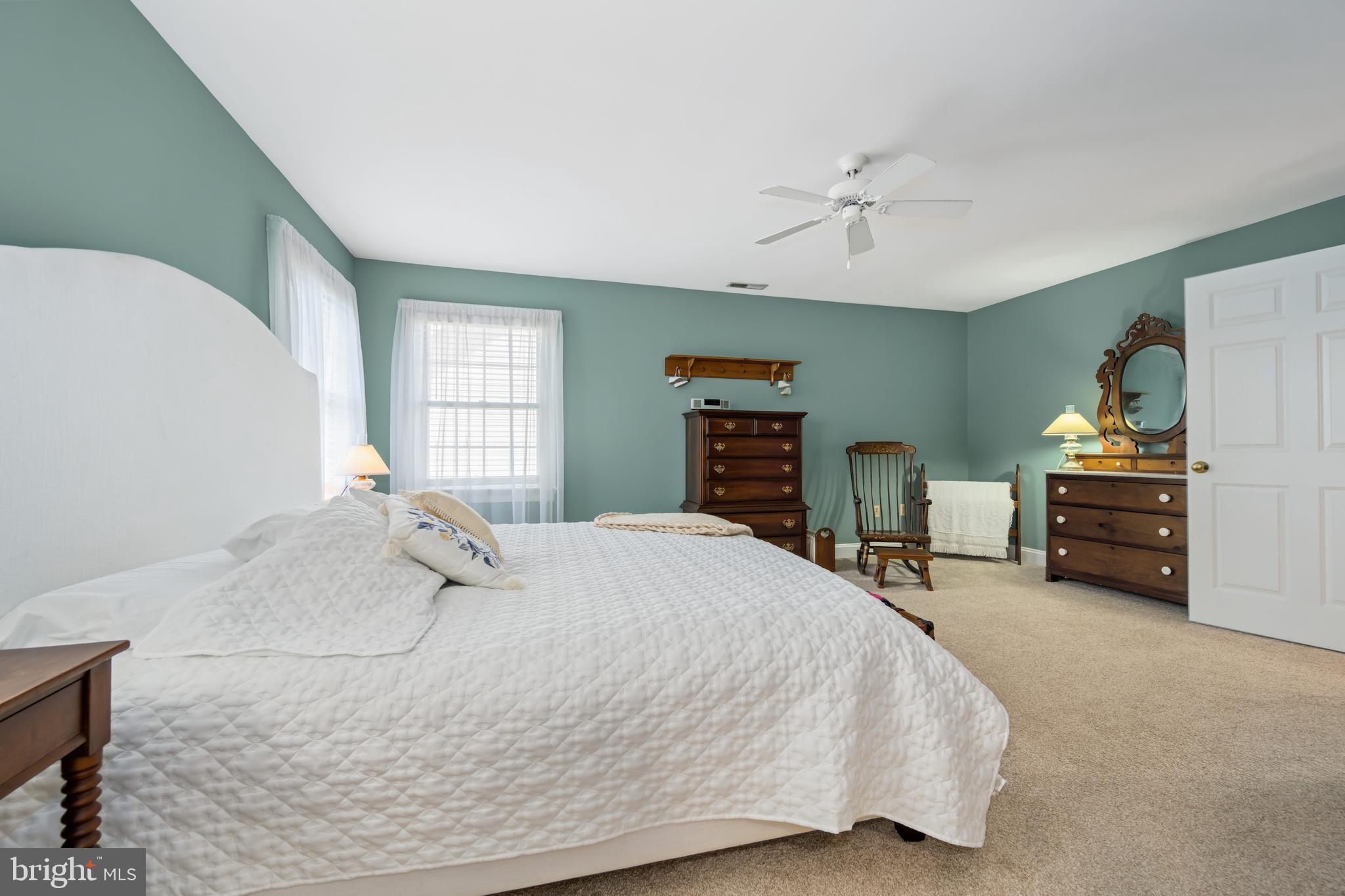 1009 South Washington Street Easton, MD 21601 - Photo 37 of 54 a bedroom with a bed and a chandelier
