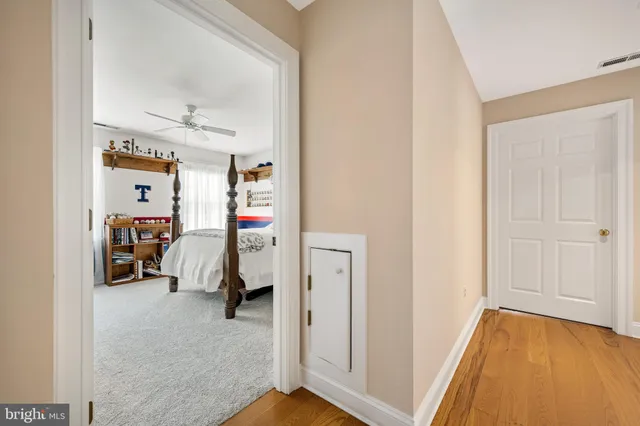 a view of a bedroom with a bed and a window