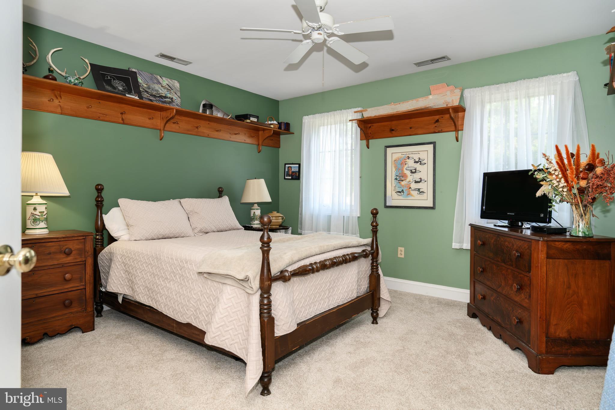 1009 South Washington Street Easton, MD 21601 - Photo 42 of 54 a bedroom with a bed and a flat tv screen on dresser