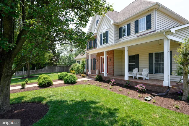 a view of a house with backyard sitting area and garden