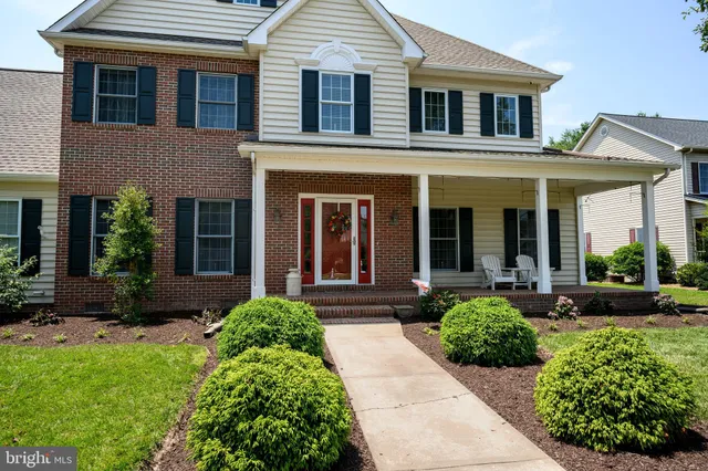 a view of a brick house with potted plants and a large window
