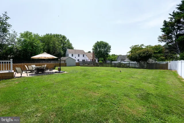 a view of a house with backyard sitting area and garden