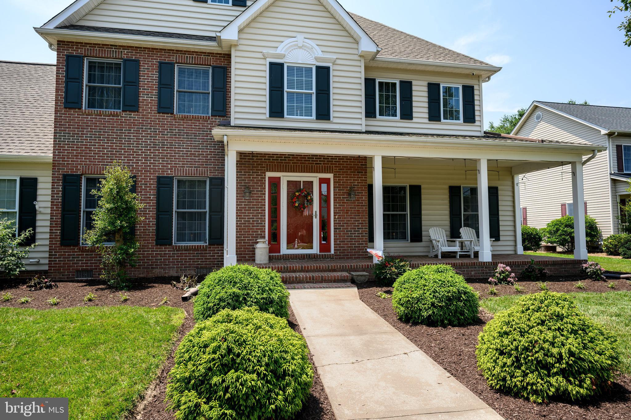 1009 South Washington Street Easton, MD 21601 - Photo 10 of 54 a view of a brick house with potted plants and a large window