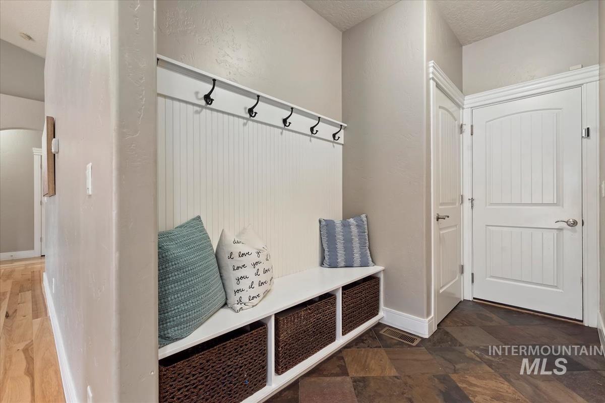 640 Southwest Miner Street Mountain Home, ID 83647 - Photo 35 of 35 Entryway featuring a built-in bench with integrated storage and a beadboard wall with coat hooks