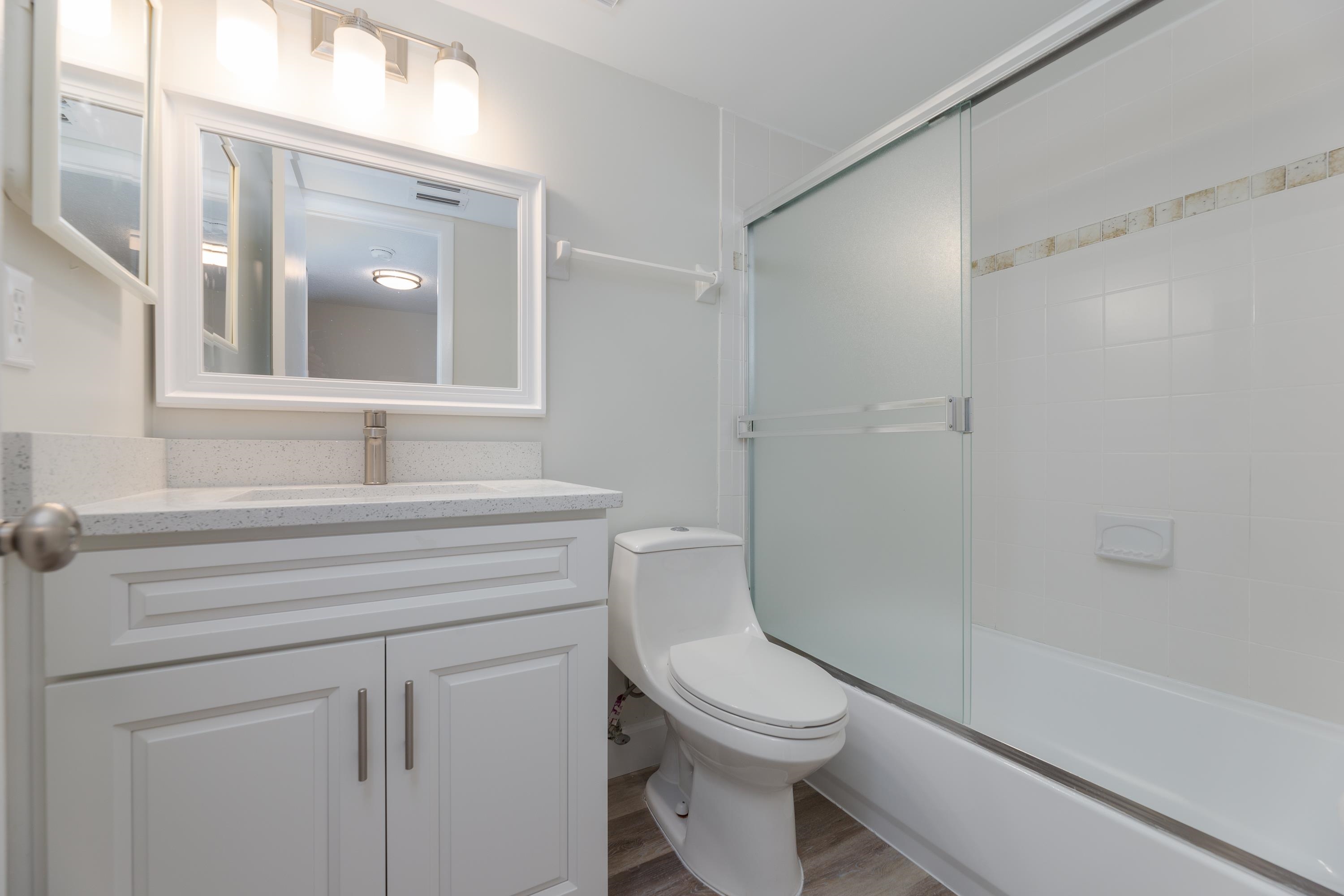 390 A1A Beach Boulevard, Unit 48 St. Augustine, FL 32080 - Photo 11 of 24 a bathroom with a sink a toilet and shower