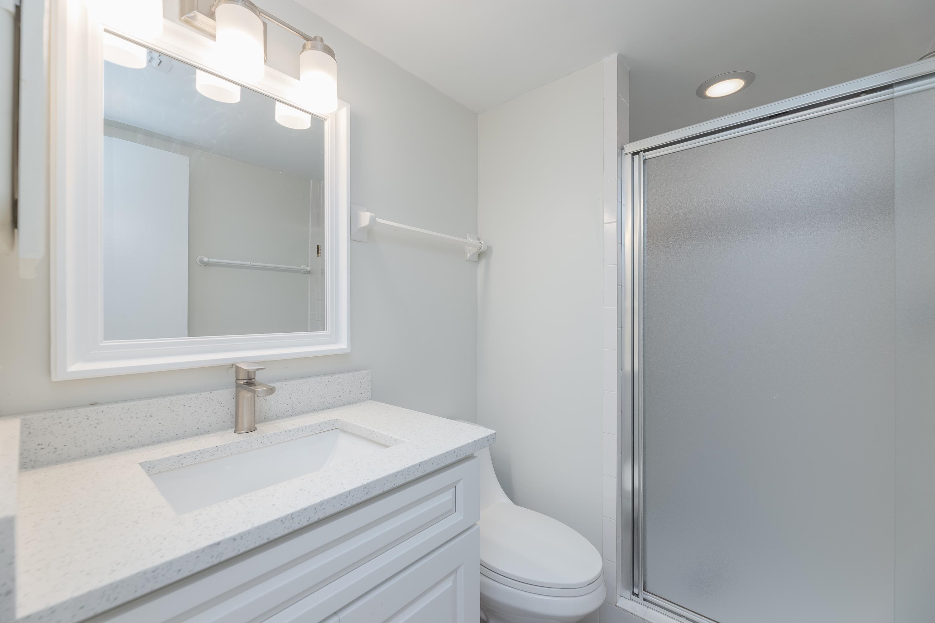 390 A1A Beach Boulevard, Unit 48 St. Augustine, FL 32080 - Photo 13 of 24 a bathroom with a sink a toilet and shower