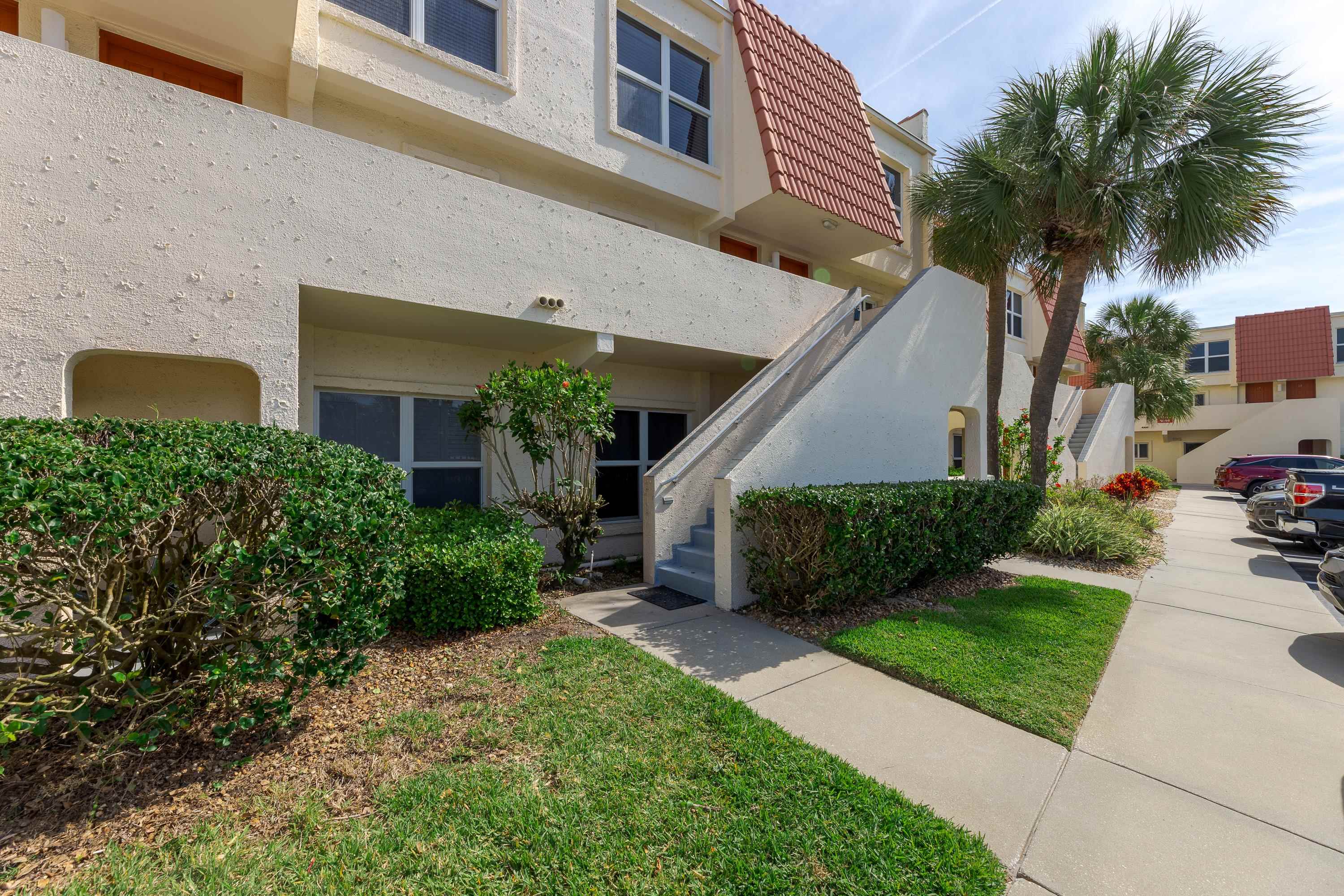 390 A1A Beach Boulevard, Unit 48 St. Augustine, FL 32080 - Photo 23 of 24 front view of a house with a yard
