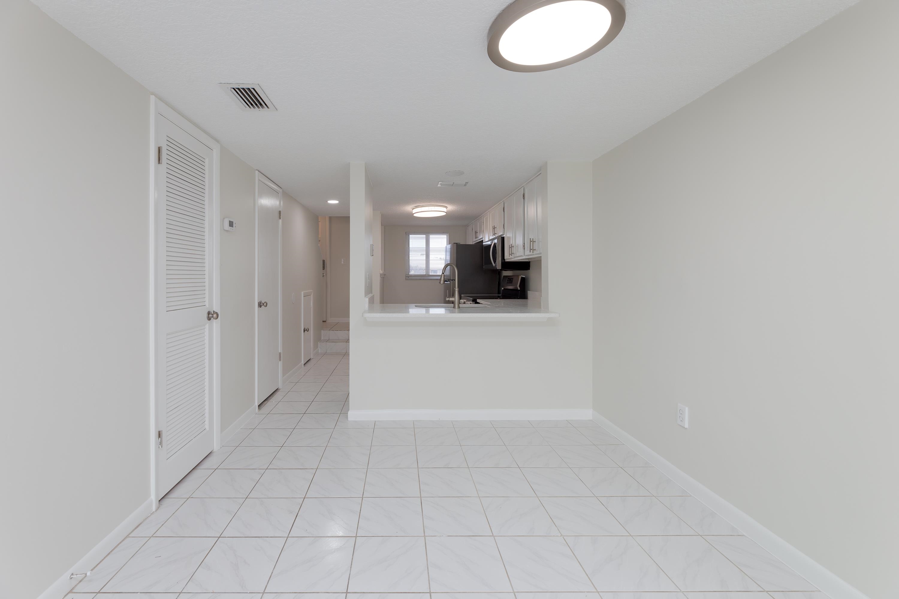 390 A1A Beach Boulevard, Unit 48 St. Augustine, FL 32080 - Photo 5 of 24 a view of a storage & utility room with a sink