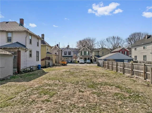 a view of a town with large trees and barn