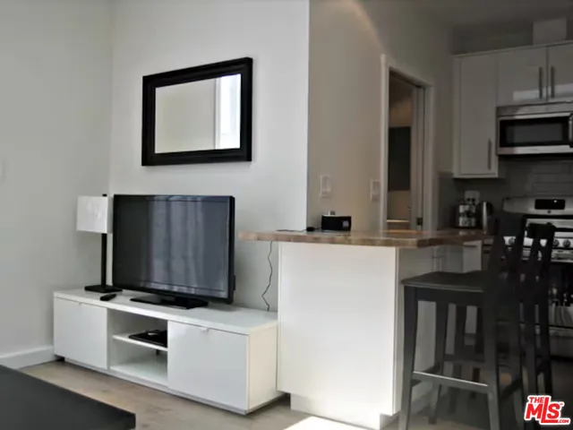 a kitchen with stainless steel appliances a stove microwave and cabinets