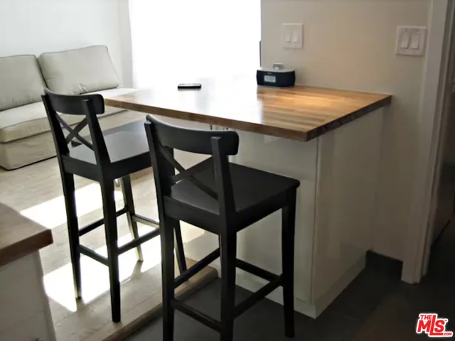 a bed sitting in a bedroom next to a lamp